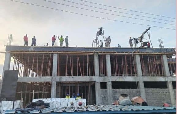 Crew placing concrete on an upper slab